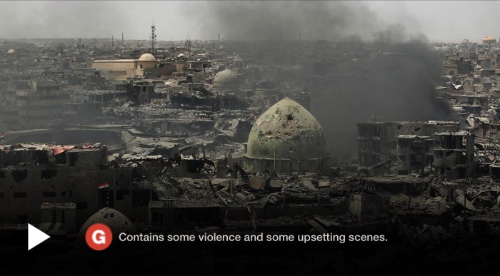 A video frame with bombing damage and a trigger warning saying “Contains some violence and some upsetting scenes”